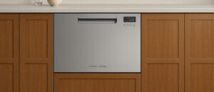 Fisher & Paykel DD24SAX9N dishwasher review featuring a stainless steel single DishDrawer built into a modern wooden kitchen cabinet.