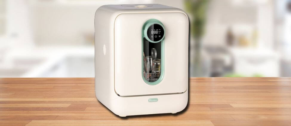 In this IAGREEA TBXQR02 Baby Bottle Washer Review image, the countertop washer is displayed on a counter in a kitchen, showcasing its stylish appearance and practical placement for everyday use.
