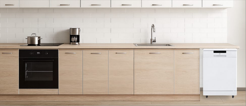 A sleek, modern kitchen featuring minimalistic cabinetry and polished surfaces. Positioned neatly in the corner, the freestanding SPT SD-6513SS dishwasher blends convenience with flexibility, showing how well it fits into a functional yet dynamic kitchen space.