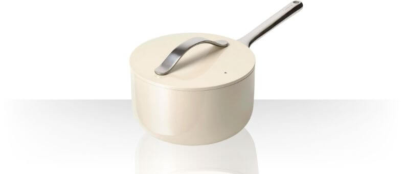 Caraway Nonstick Ceramic Saucepan in cream color with matching lid and sleek stainless steel handle.