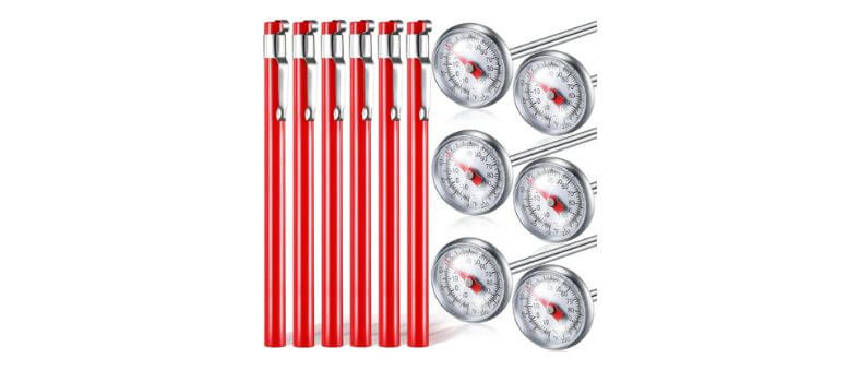 A set of six stainless steel dial thermometers with red protective sleeves, ideal for kitchen or grilling use.