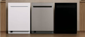 Three Kenmore Elite dishwashers in white, stainless steel, and black finishes are displayed side by side against a cozy wall background, highlighting their sleek handle design and modern built-in style for the Kenmore Elite dishwasher review.