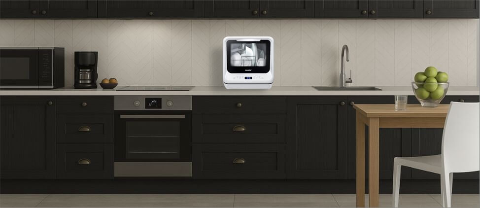 A visual size comparison chart displaying theCOMFEE CDC17P0AWB dishwasher alongside a standard kitchen counter and average human heights. The graphic helps users understand its compact dimensions and how it fits within a regular kitchen environment.