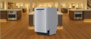 In this Bosch SPE53B55UC Dishwasher Review image, the built-in (under-counter) dishwasher is displayed in a showroom setting, highlighting its modern design and front panel.