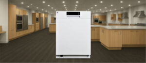 Feature image of Kenmore 2214602 Dishwasher Review: The image shows the built-in (under-counter) dishwasher is placed in an appliance showroom, displaying the dishwasher’s refined and modern look, with a streamlined front panel and stylish build that complements today’s kitchens.