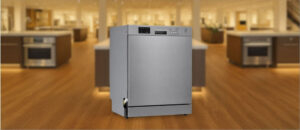 Feature image of Danby DDW2400ESS Dishwasher Review: The image shows the built-in (under-counter) dishwasher is placed in an appliance showroom, displaying the dishwasher’s refined and modern look, with a streamlined front panel and stylish build that complements today’s kitchens.