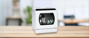 Feature image of Hermitlux HMX-DW03-1 Dishwasher Review: The image features a countertop (mini / compact) dishwasher placed on a kitchen counter, highlighting its sleek design and modern finish that fits well in small kitchens or apartments.